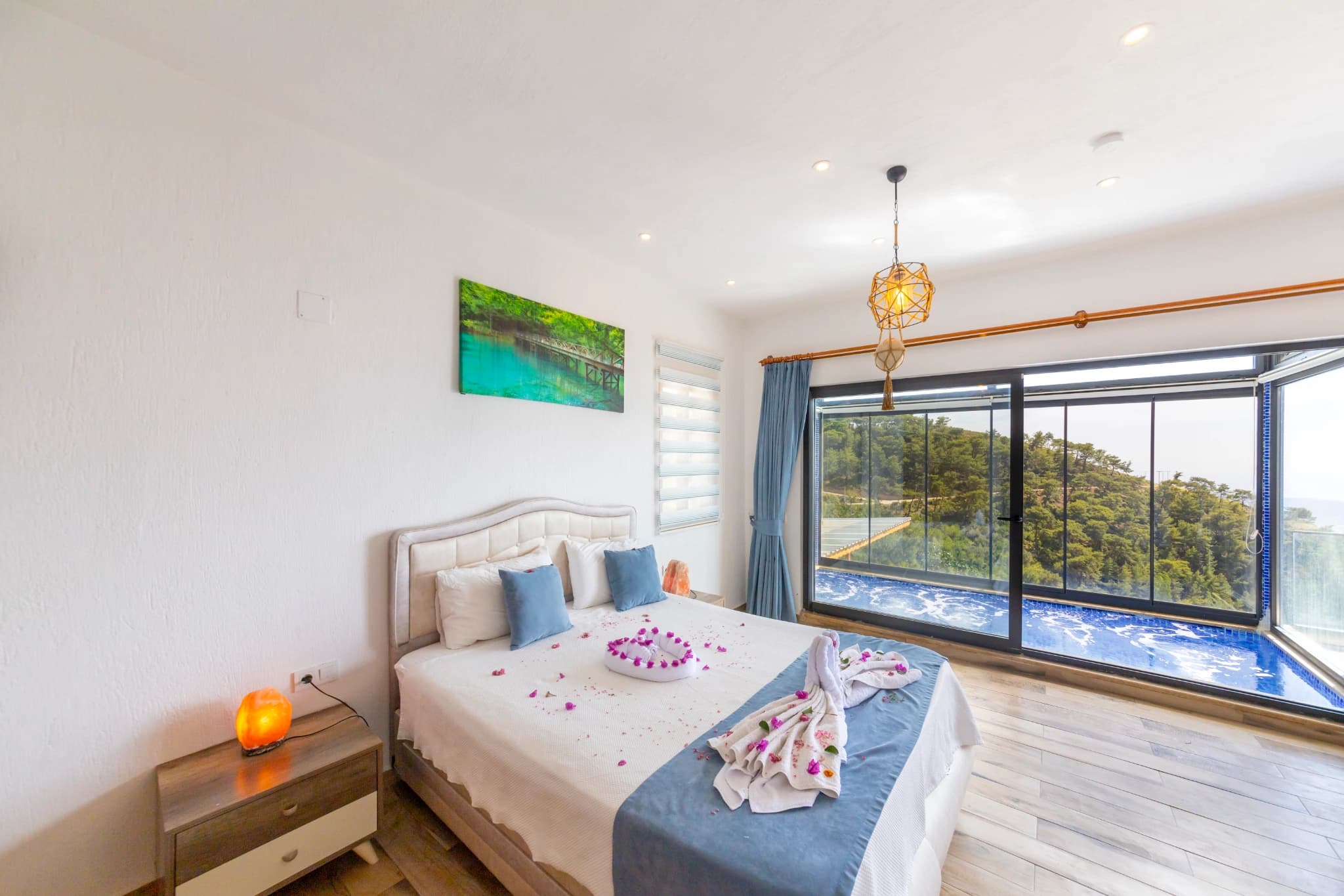 Bright bedroom with king bed and expansive sea view balcony access.
