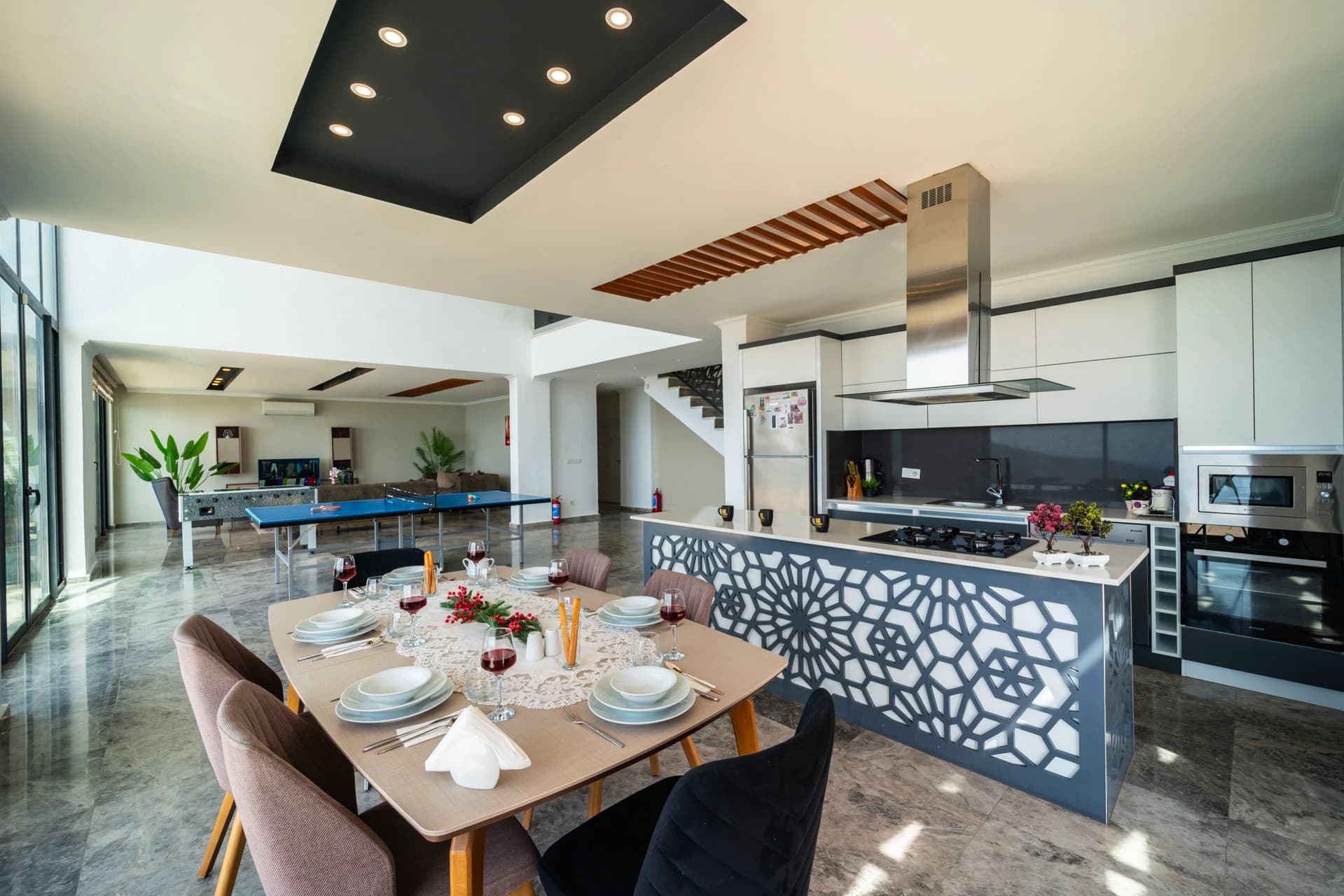 Open-plan dining and kitchen area with billiards table and sea views.