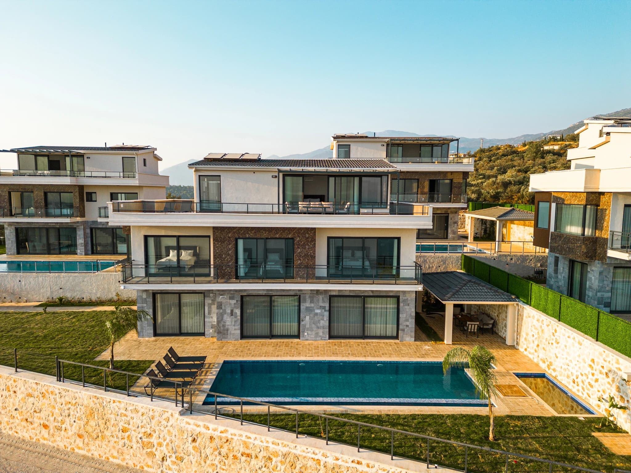 Resort-style private pool with loungers and expansive mountain vistas.