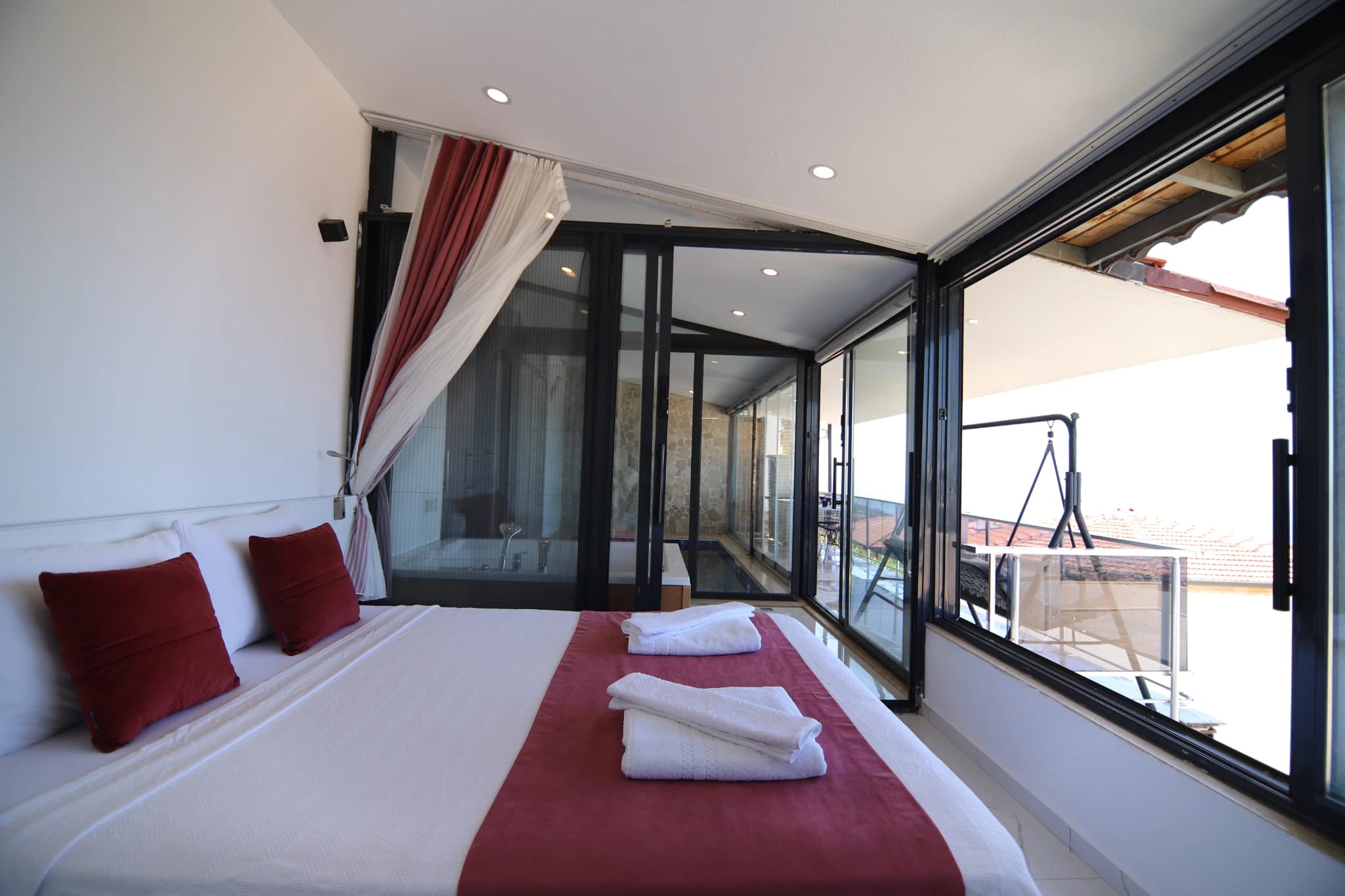 Spacious bedroom with king bed and panoramic sea-view balcony.