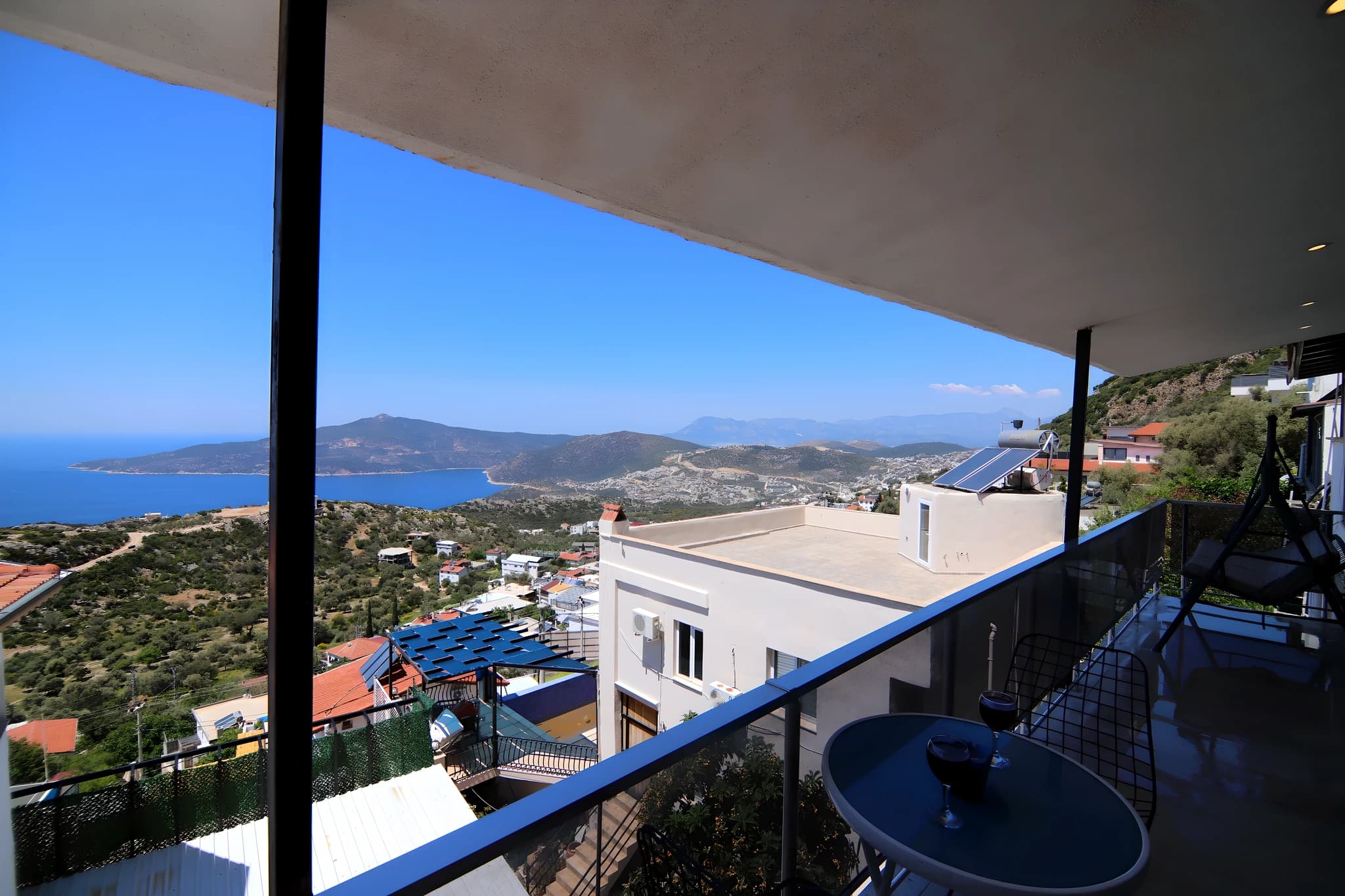 Stunning elevated terrace with breathtaking views of the turquoise sea and surrounding landscape.