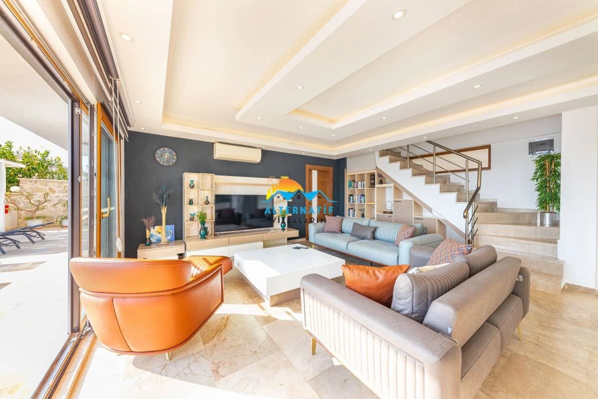 Spacious modern living room with smart TV, comfortable seating, and direct access to terrace.