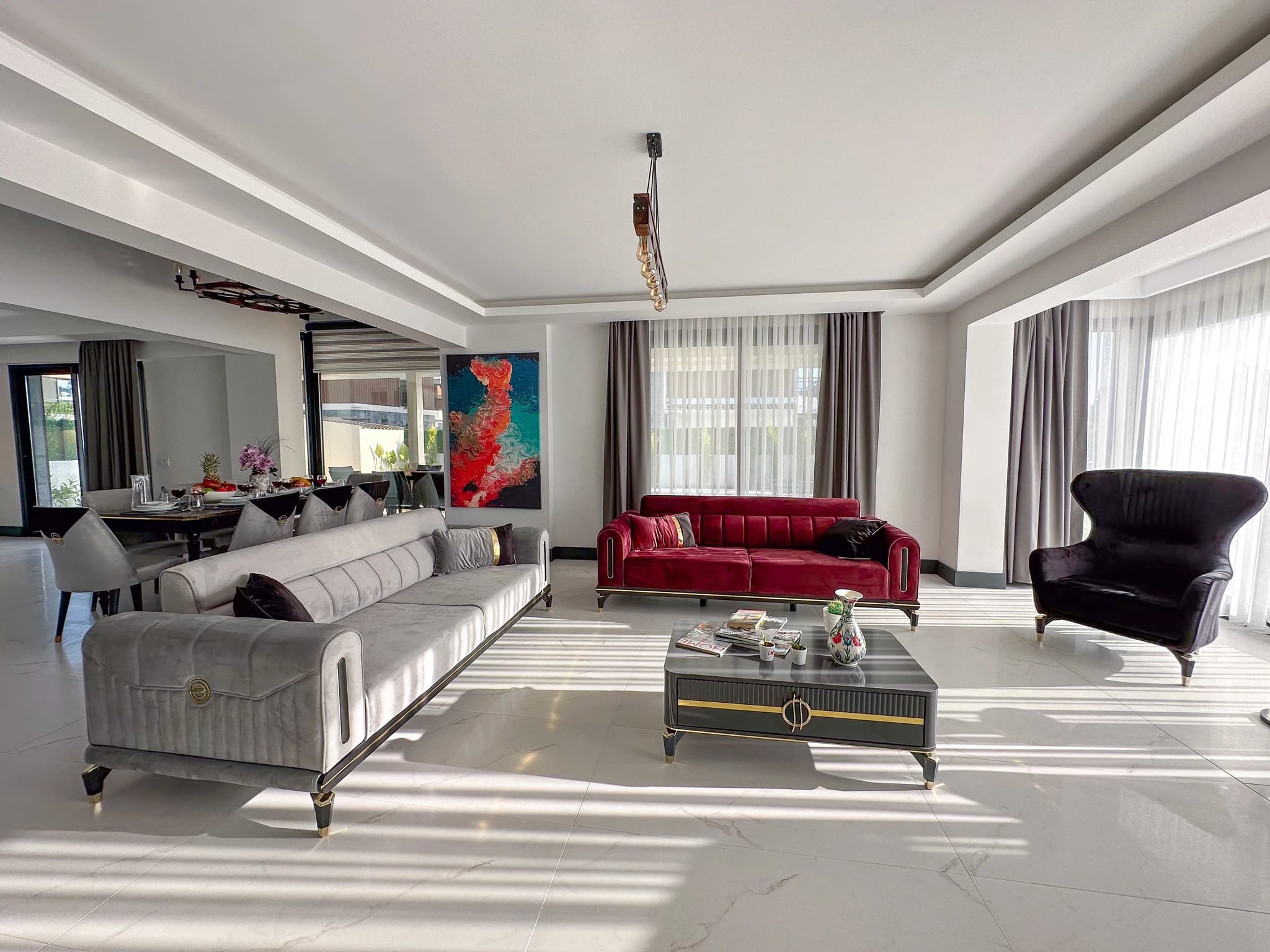 Contemporary terrace with outdoor dining table, comfortable seating, and landscaped garden views.