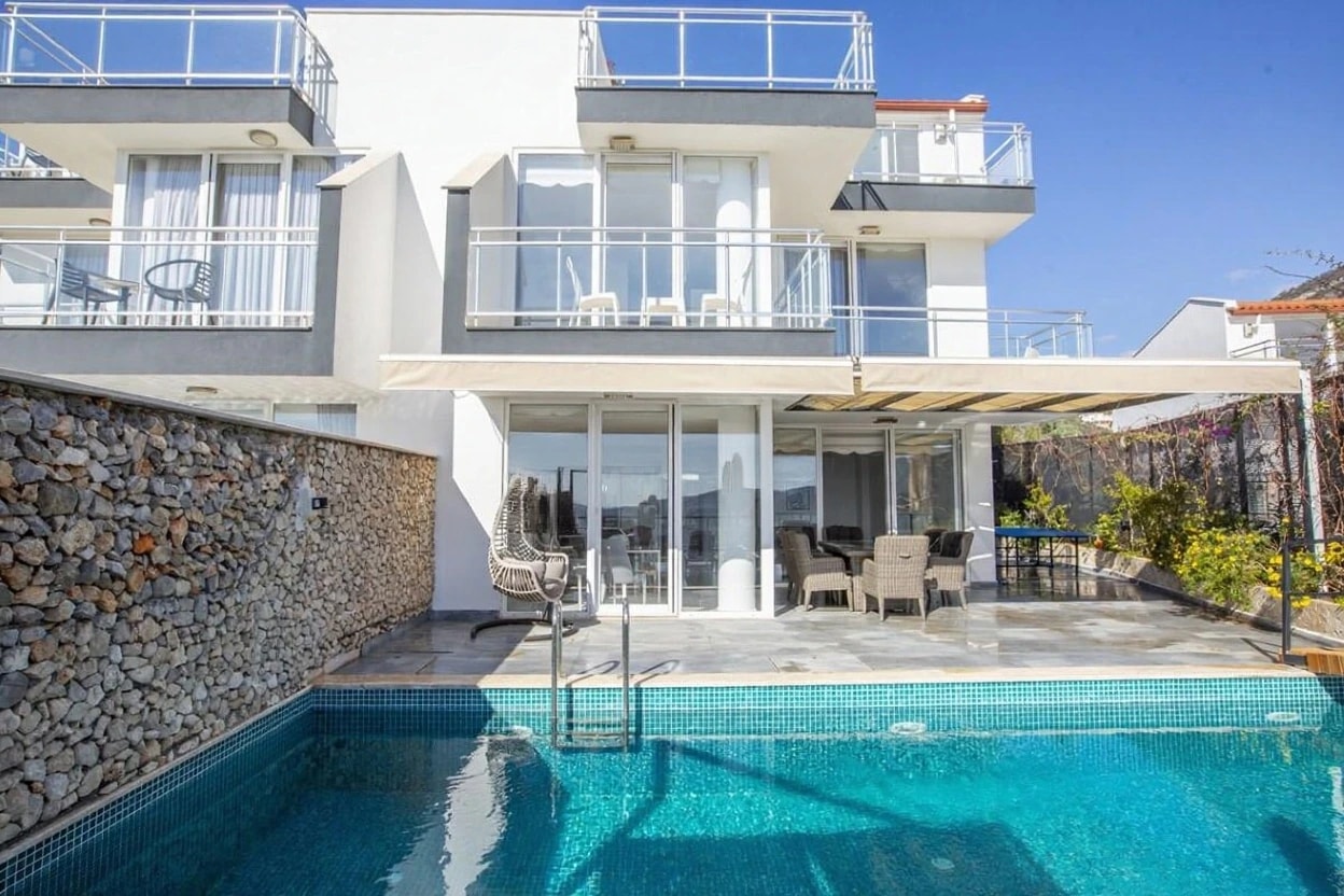 Expansive poolside terrace with contemporary shade structures and pristine architectural lines.
