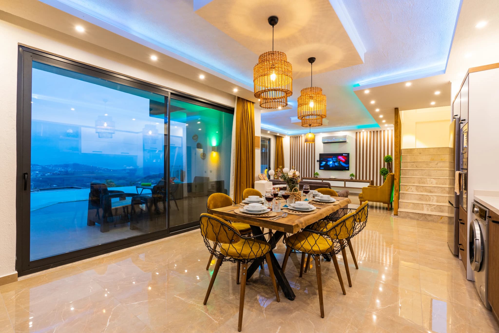 Elegant dining area with panoramic sea views through floor-to-ceiling windows.