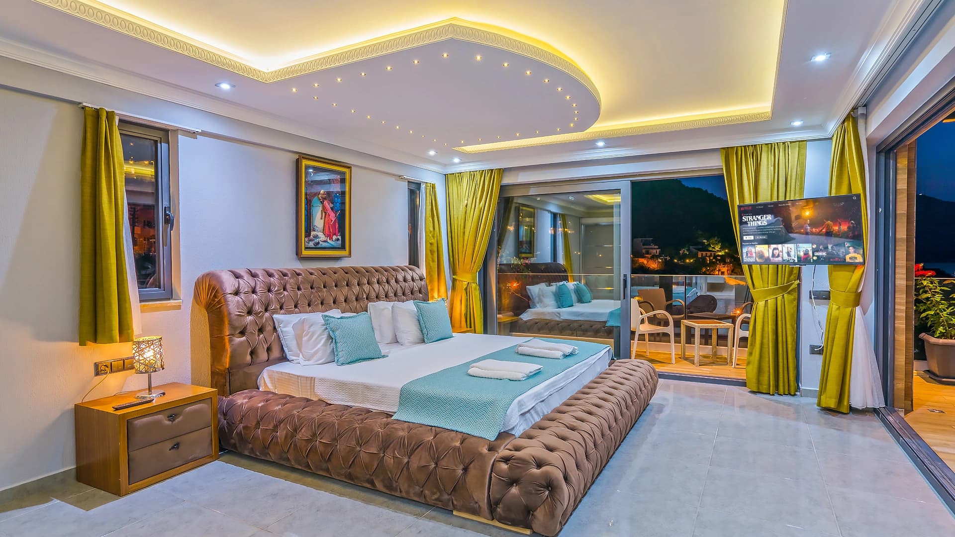 Luxurious master bedroom with tufted king bed, ensuite bathroom, and panoramic sea view balcony.
