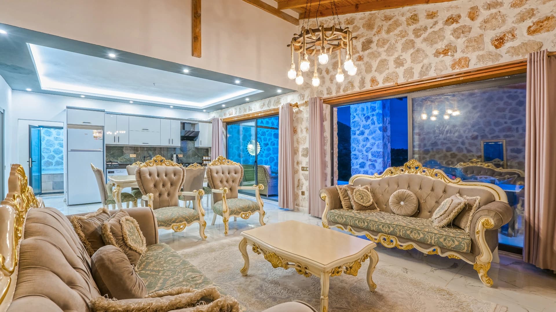 Opulent living room with dramatic sea and pool views through floor-to-ceiling windows.
