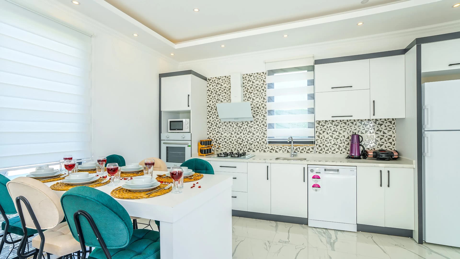Modern fully-equipped kitchen with integrated dining and premium finishes.