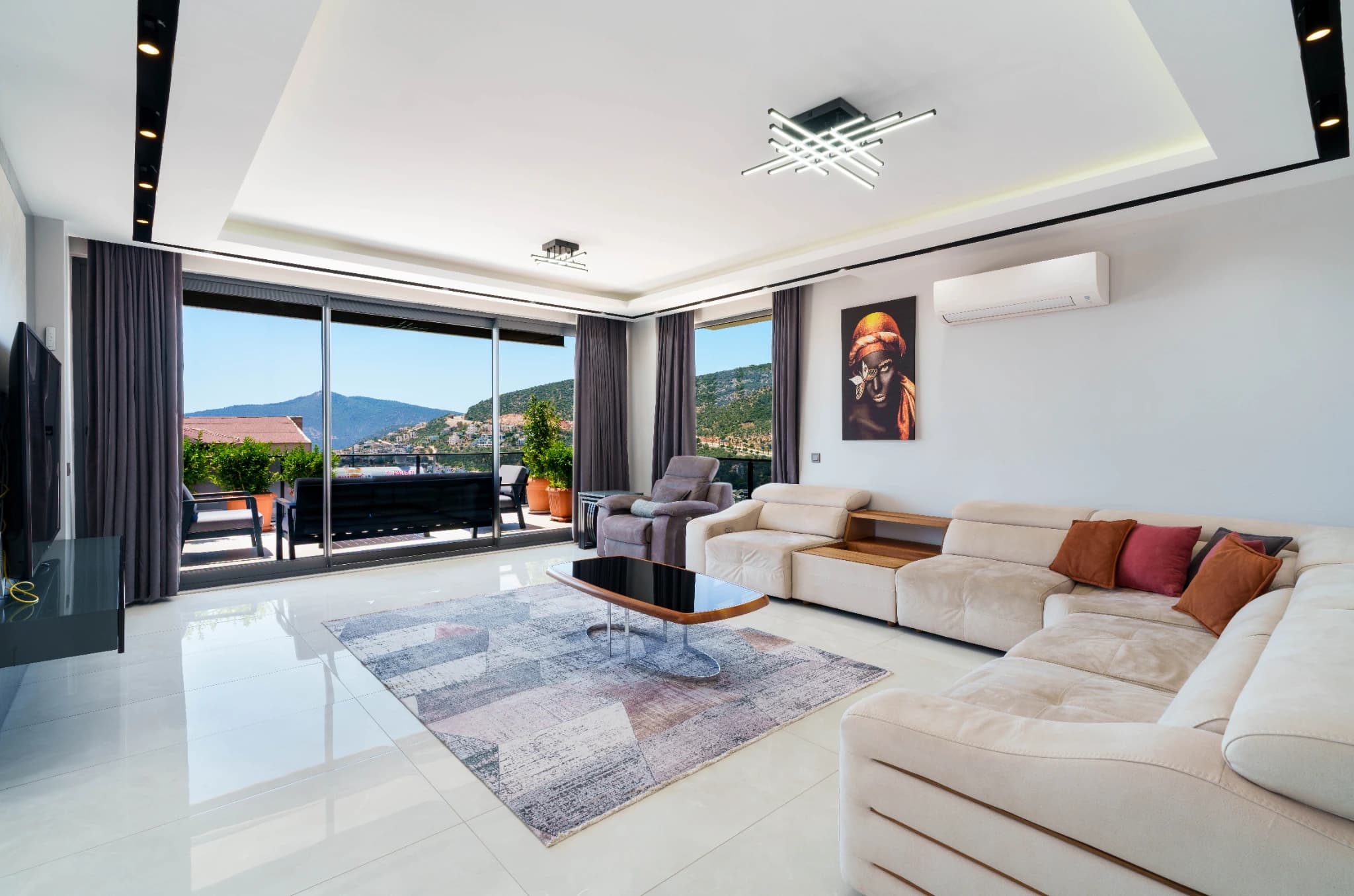 Expansive open-plan living room with luxurious sectional seating, panoramic views, and access to a terrace.