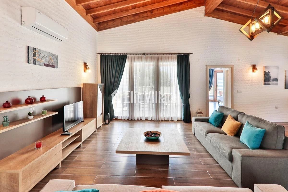 Spacious living room with comfortable seating, smart TV, and access to terrace.