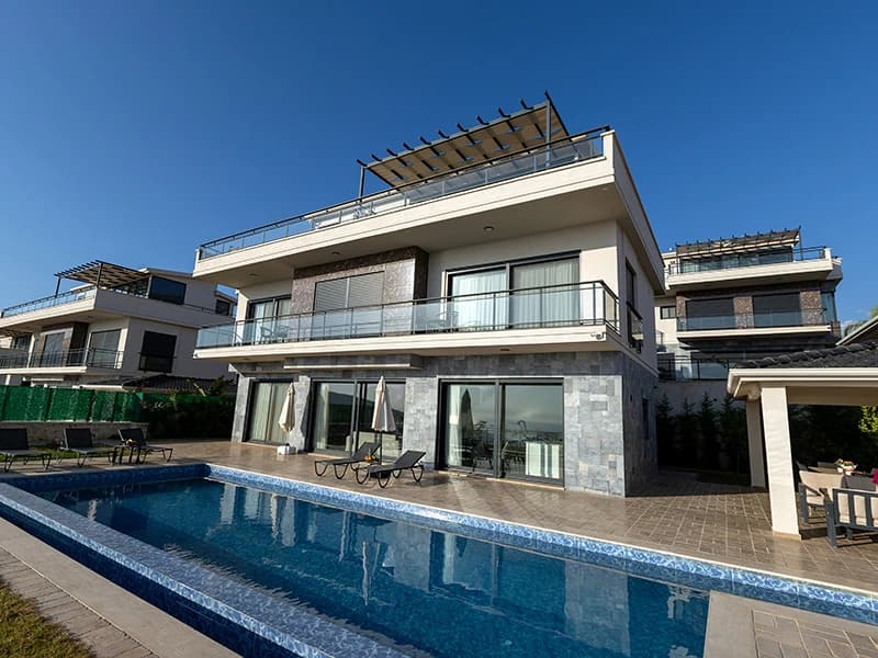 Contemporary villa exterior with private lap pool, multiple terraces, and architectural integration with landscape.