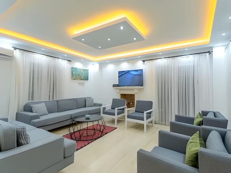 Large living room with multiple seating areas and modern design throughout.