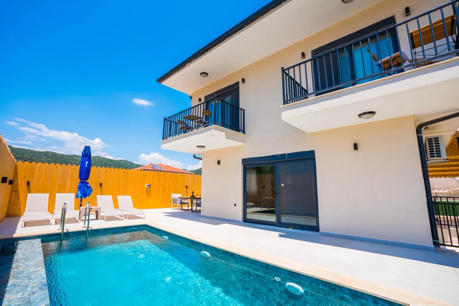 Pool area with mountain views and direct access to the villa.
