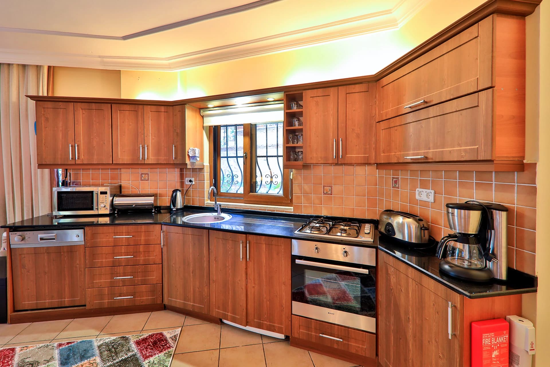 Well-equipped kitchen with wooden cabinetry and modern appliances.