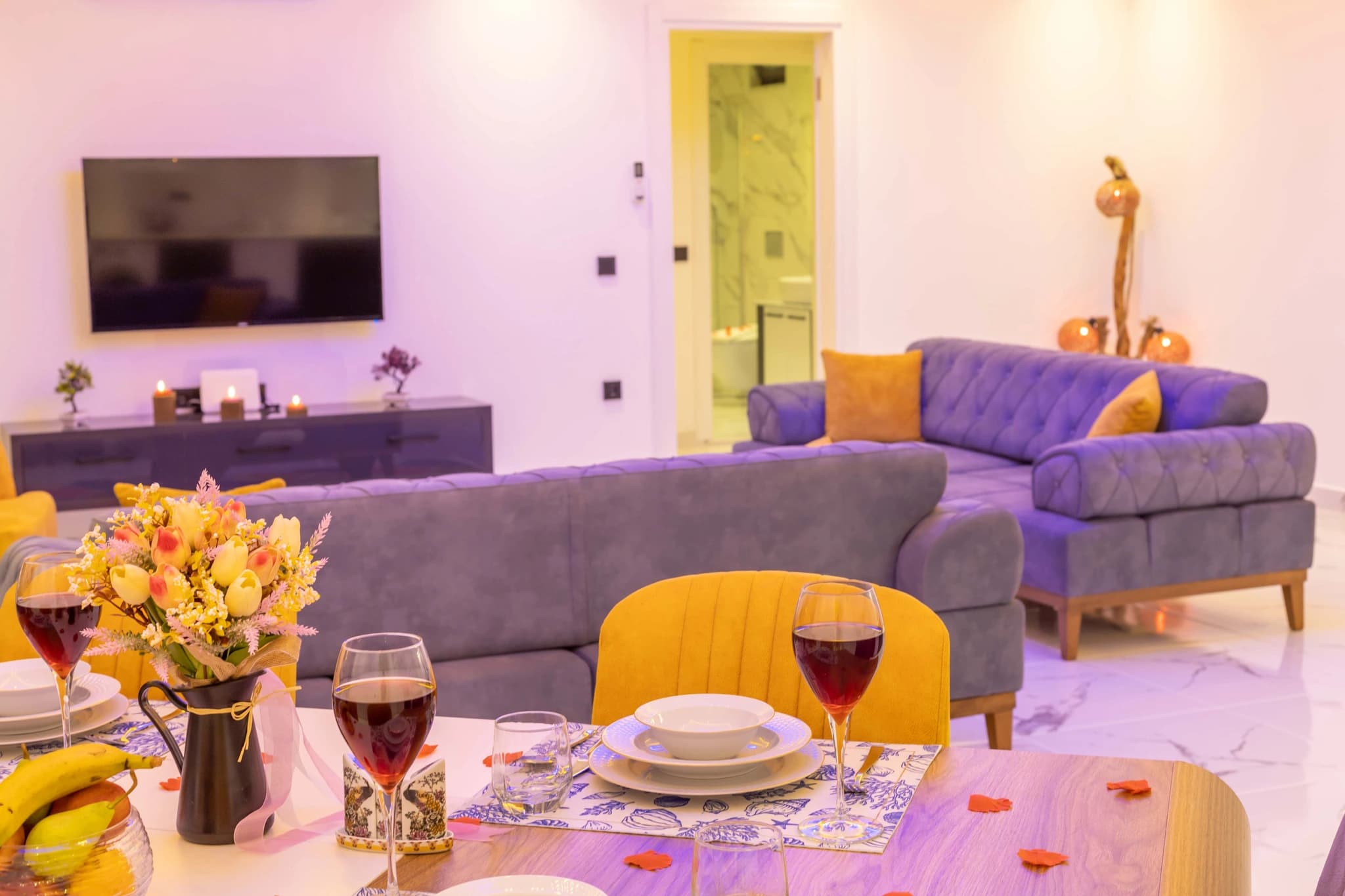 Secluded Garden Villa with Private Pool and Mountain Views in Kalkan – Open-plan living and dining space with modern sofas, TV, and elegant décor.