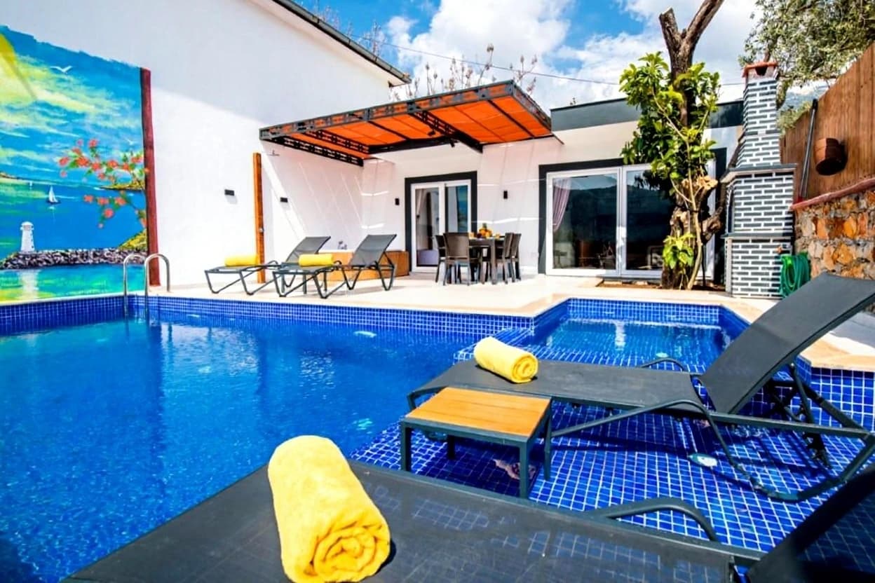 Stunning daytime pool view with lounging area and retractable orange shade.