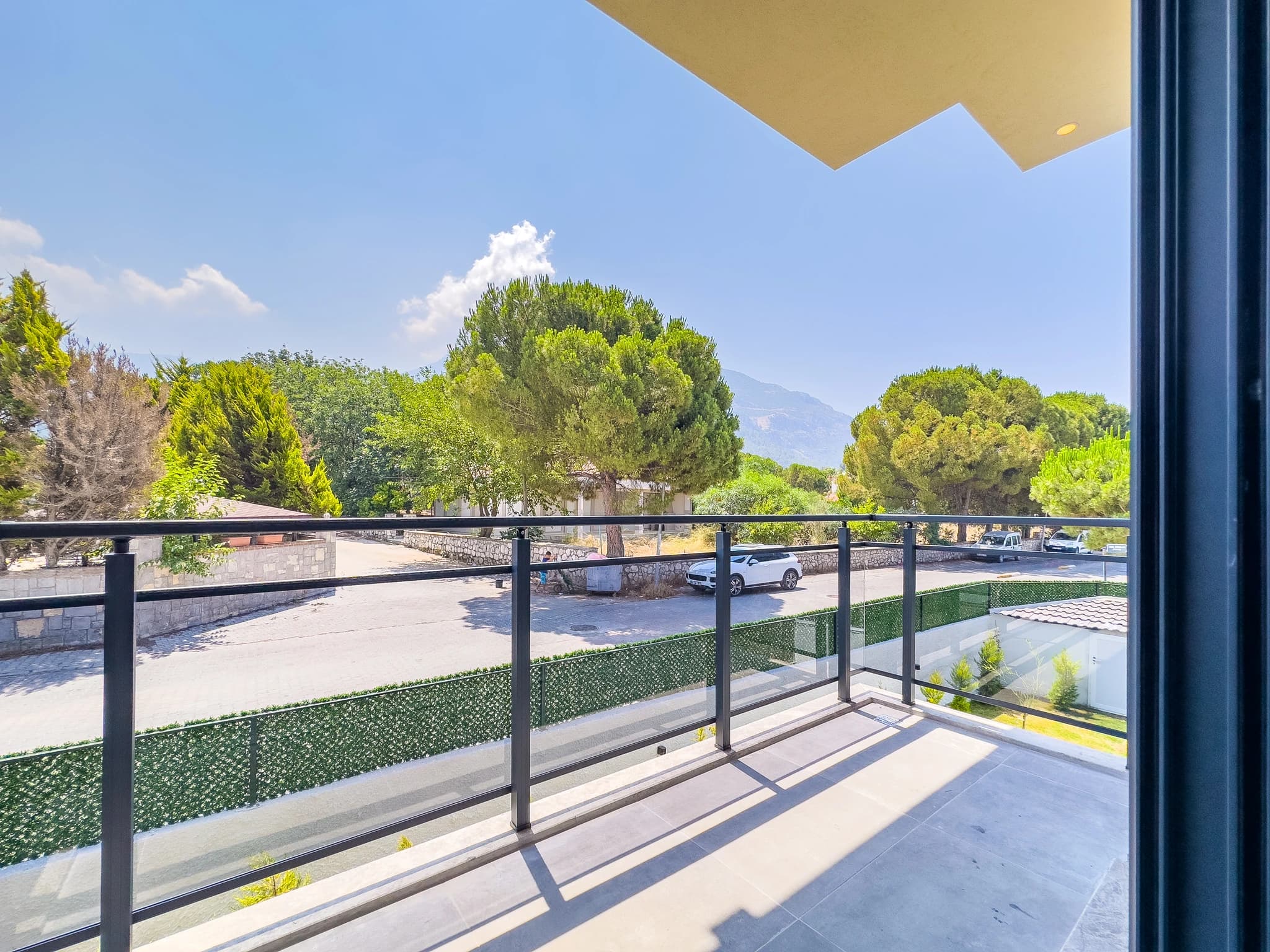 Private balcony with scenic mountain and garden views overlooking the property grounds.