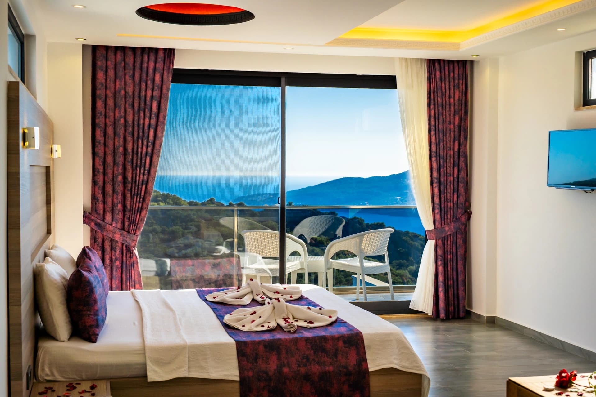 Luxurious bedroom with sea-view balcony and modern ceiling design.
