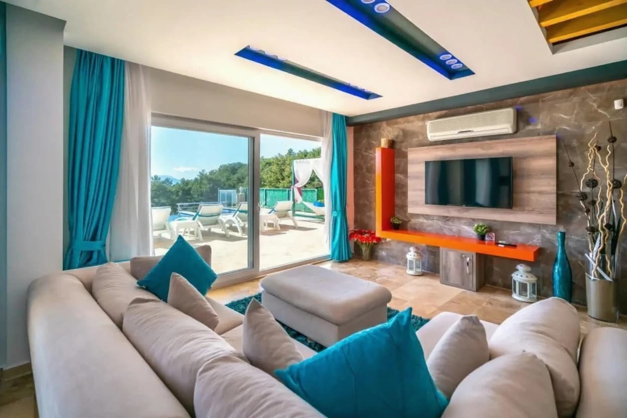 Spacious modern living room with designer furniture and direct pool terrace access.