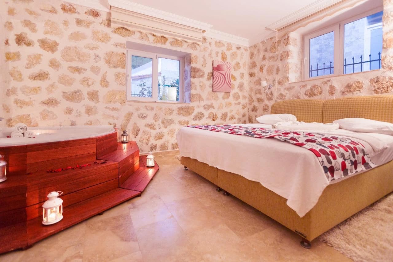 Luxurious master bedroom with integrated hot tub and romantic ambiance.
