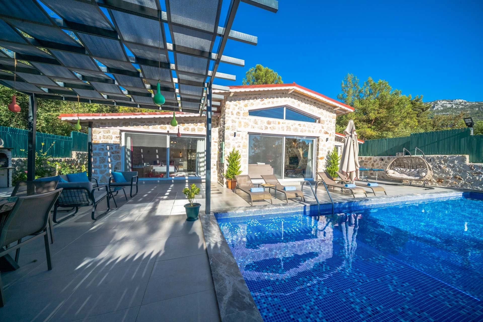 Beautiful private pool with sun loungers and modern pool house.