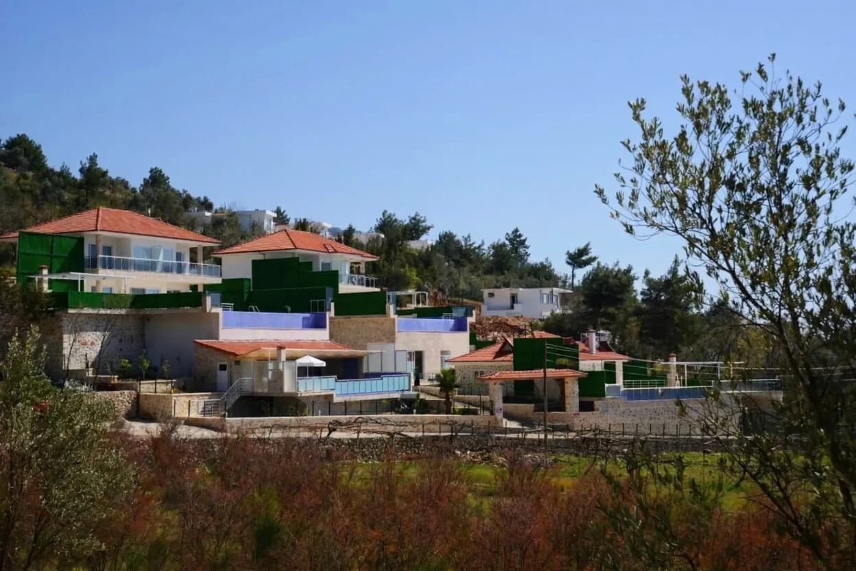 Hillside exterior view of the multi-level villa with Mediterranean architecture.