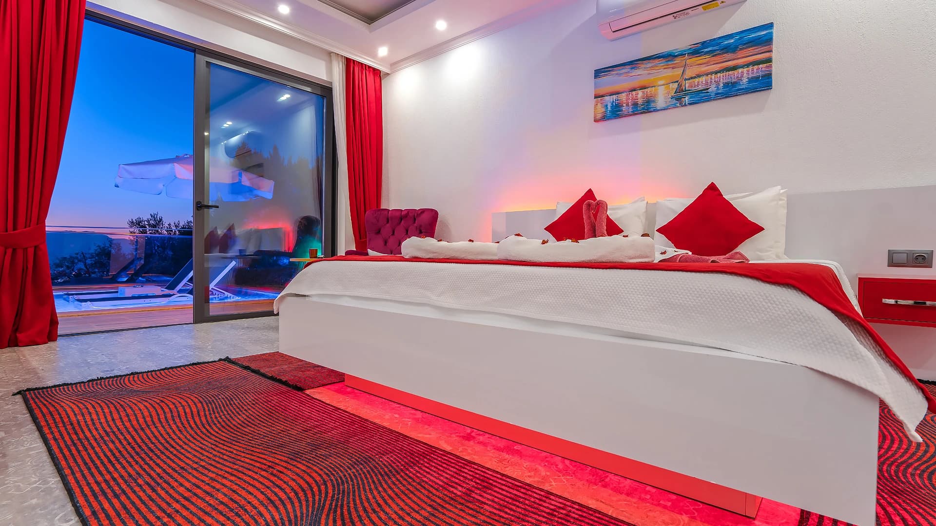 Stunning master bedroom with king bed and direct balcony overlooking the pool.