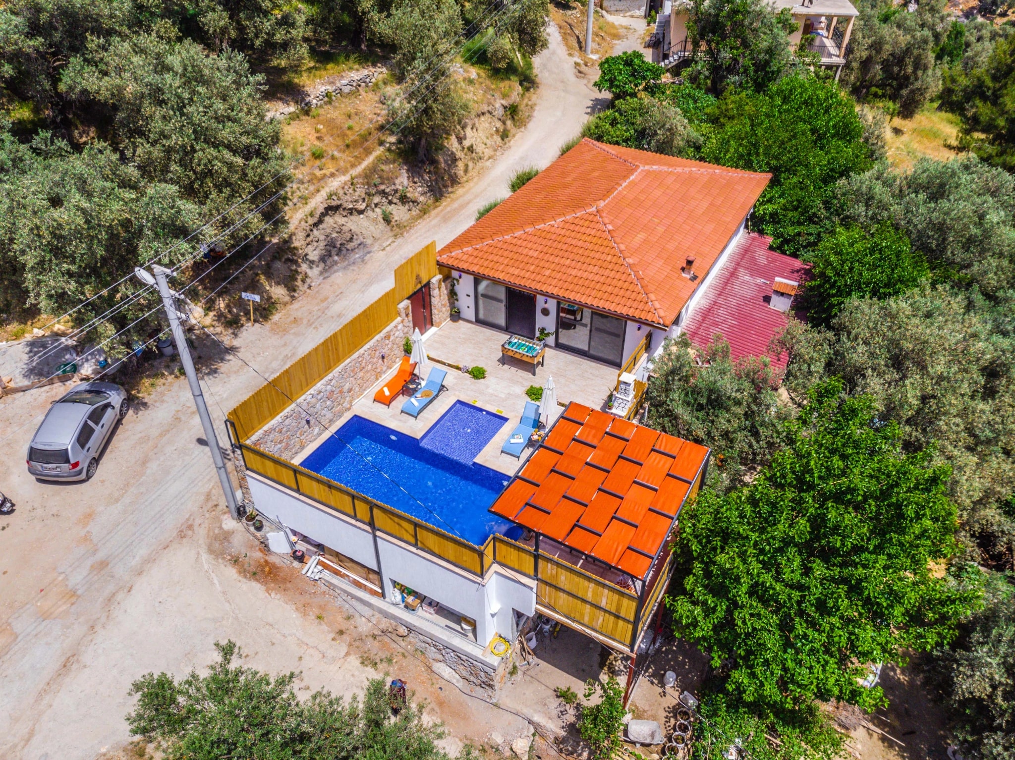 Aerial view of villa with private pool, terrace, and surrounding Mediterranean landscape.