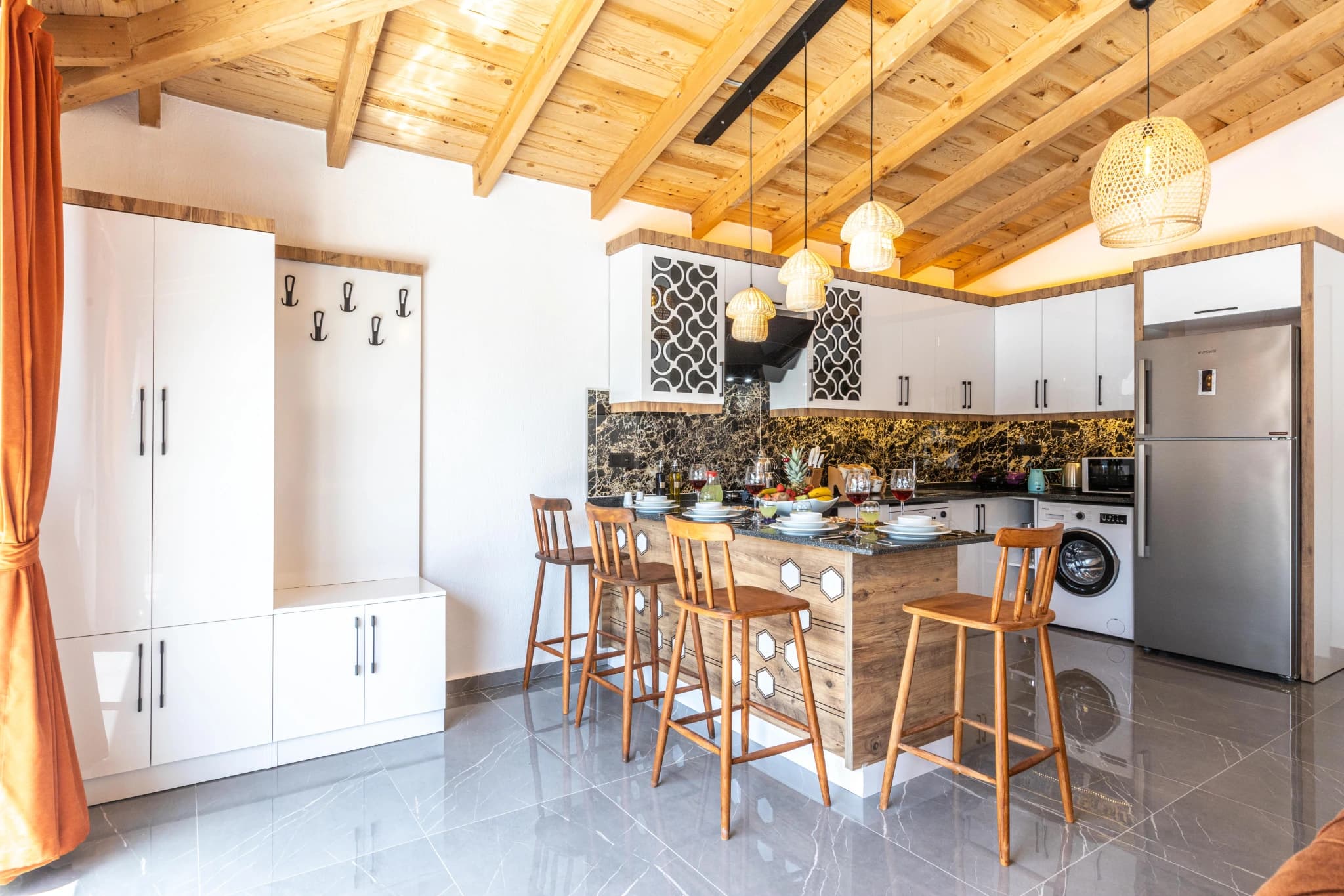 Kitchen with island counter, bar seating, and modern appliances.