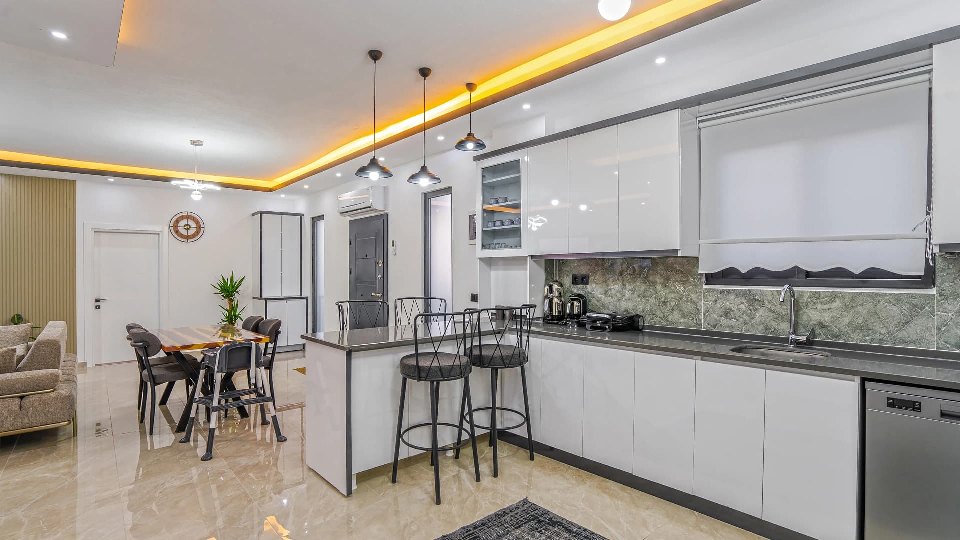 Kitchen and dining zone featuring island with seating and premium finishes.
