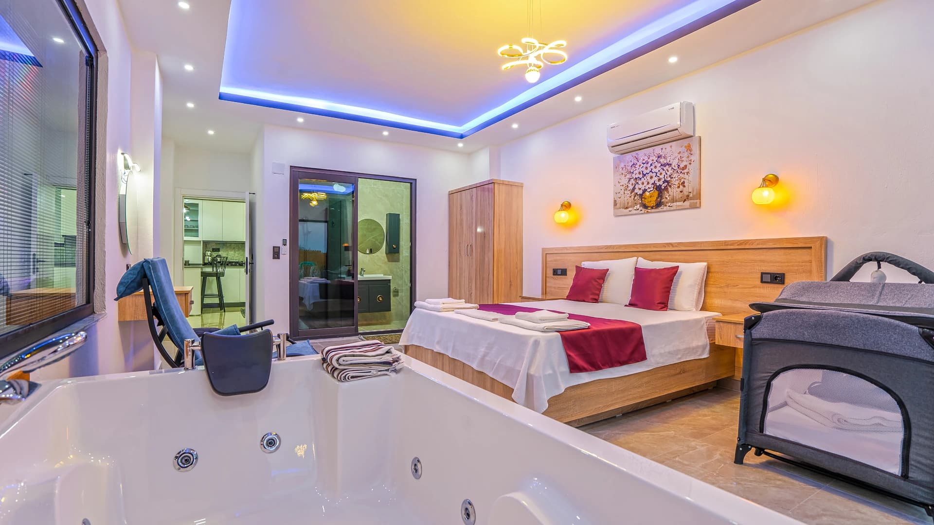 Master bedroom with integrated jacuzzi bath and luxury mood lighting.