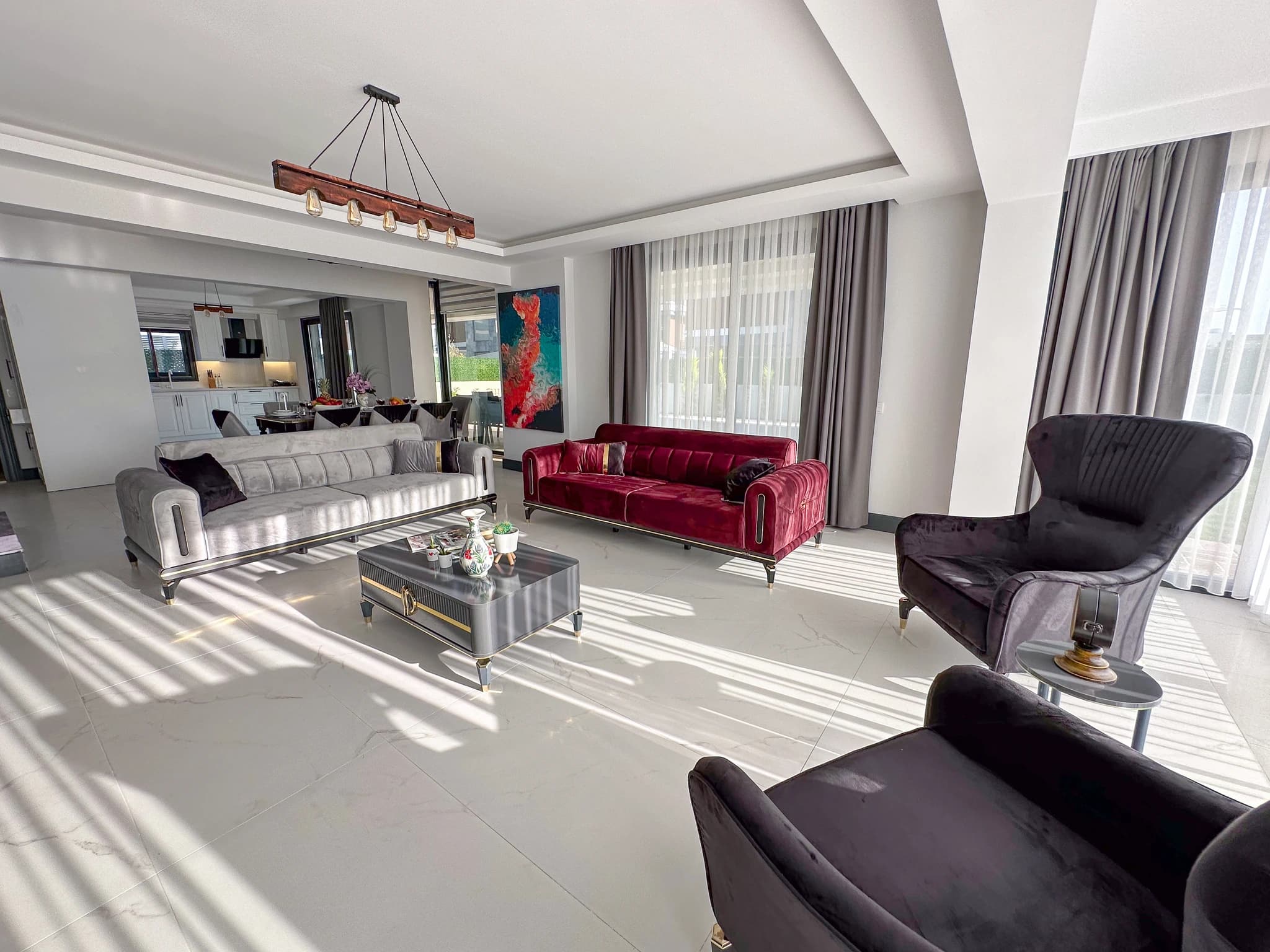 Spacious garden with lounge chairs, parasol, and private pool area.