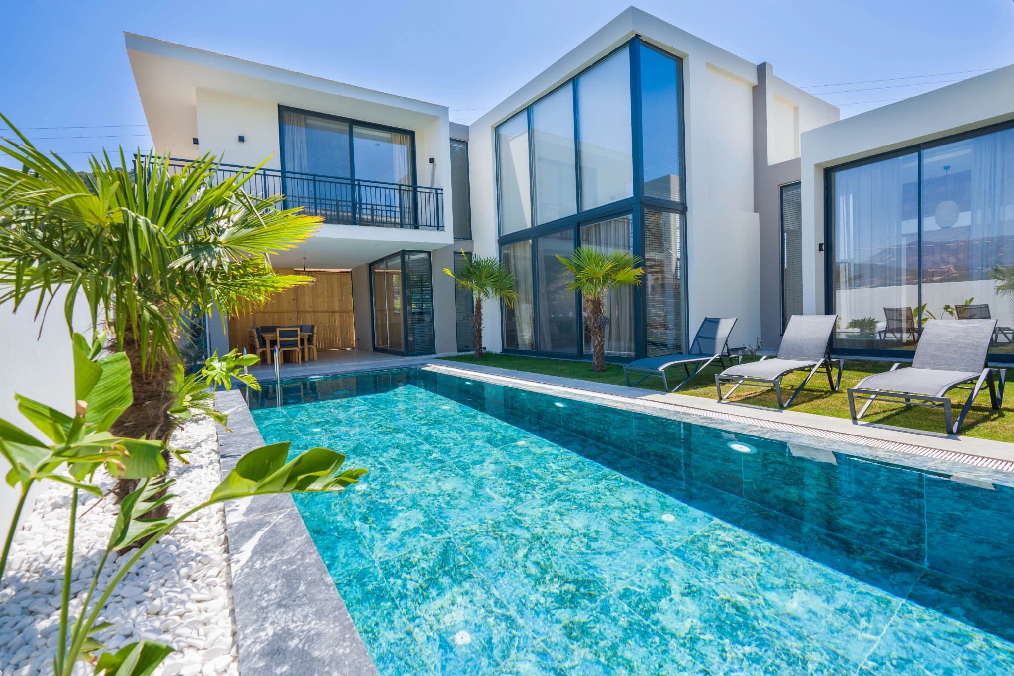 Resort-style private pool with tropical landscaping and contemporary design.