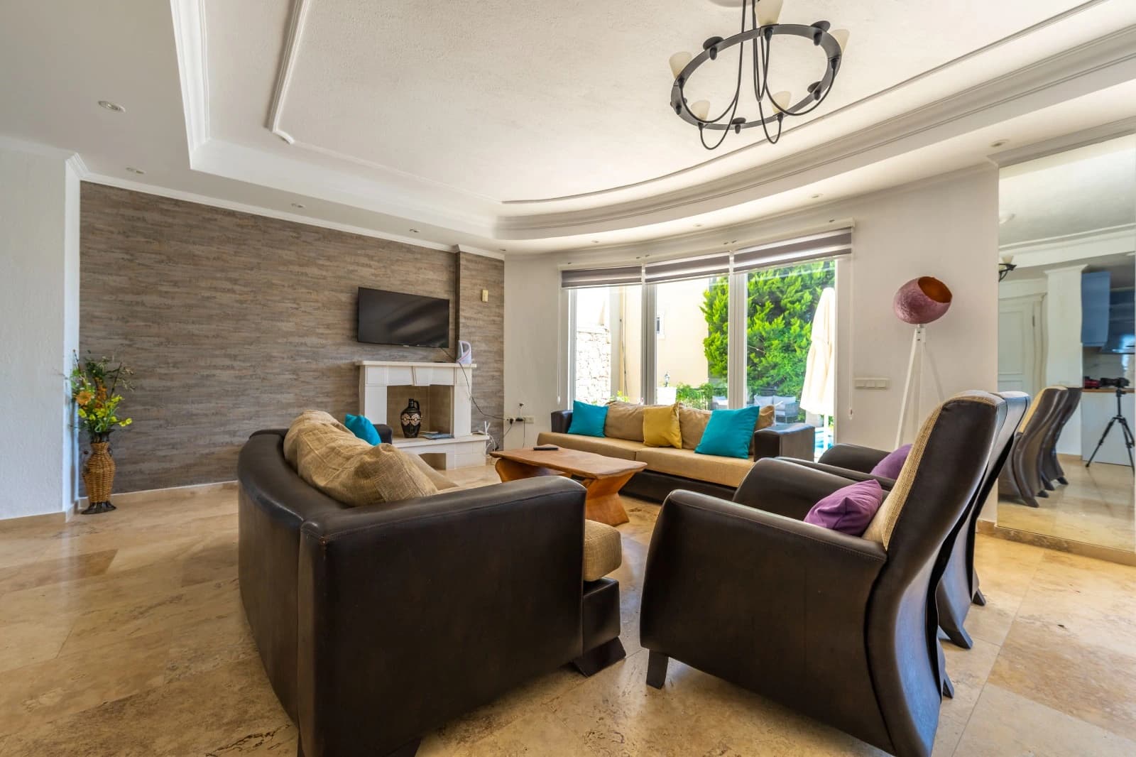 Spacious living room with fireplace, flat-screen TV, and contemporary furnishings.