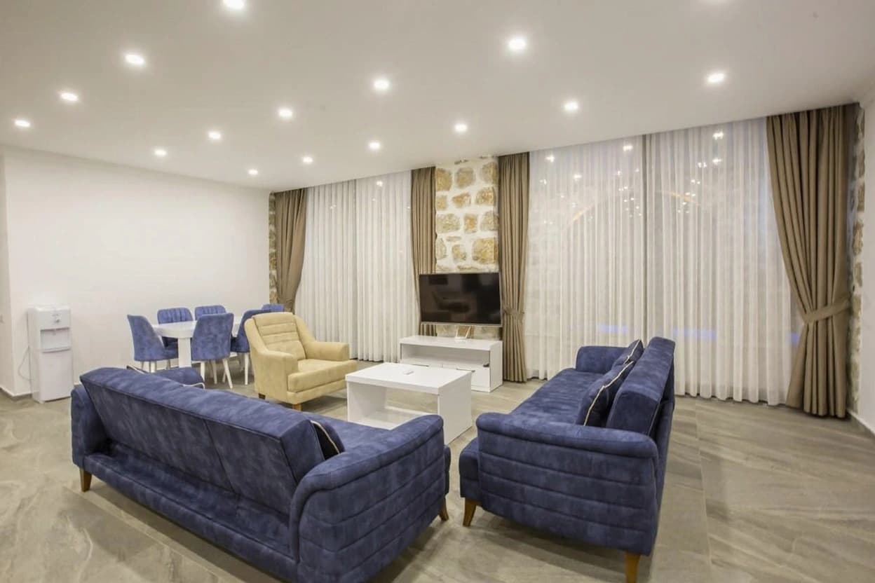 Modern living room with comfortable seating and large windows overlooking views.