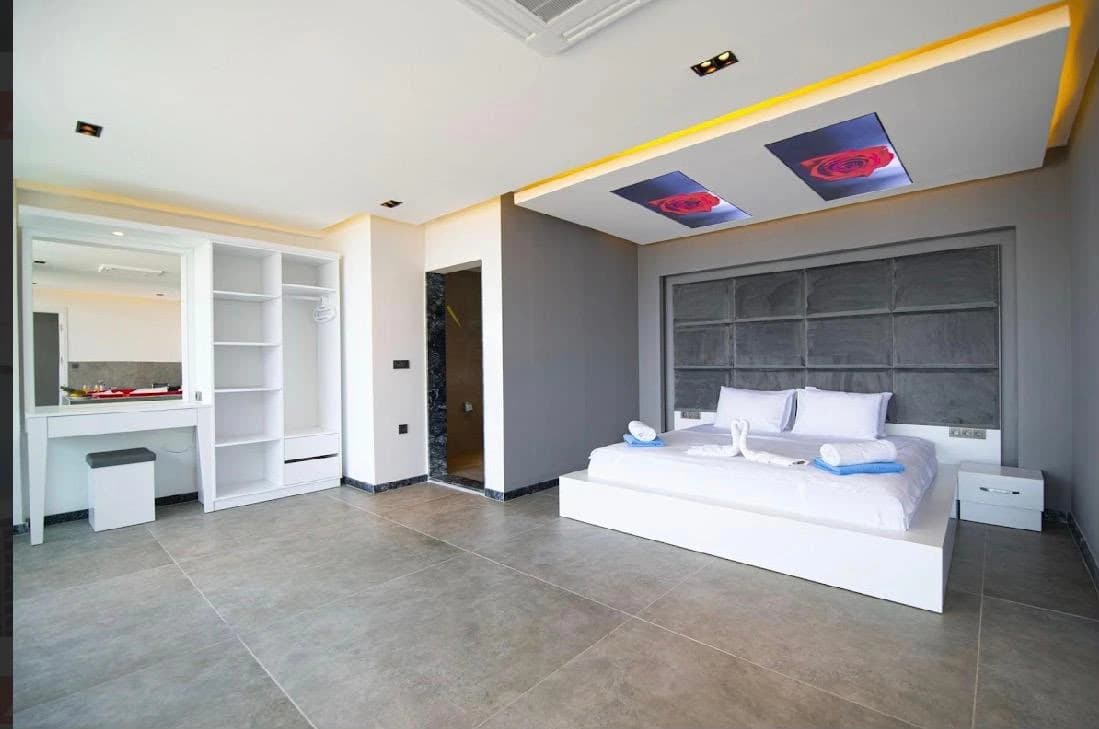 Spacious master bedroom with king bed, ensuite bathroom, and walk-in wardrobe.