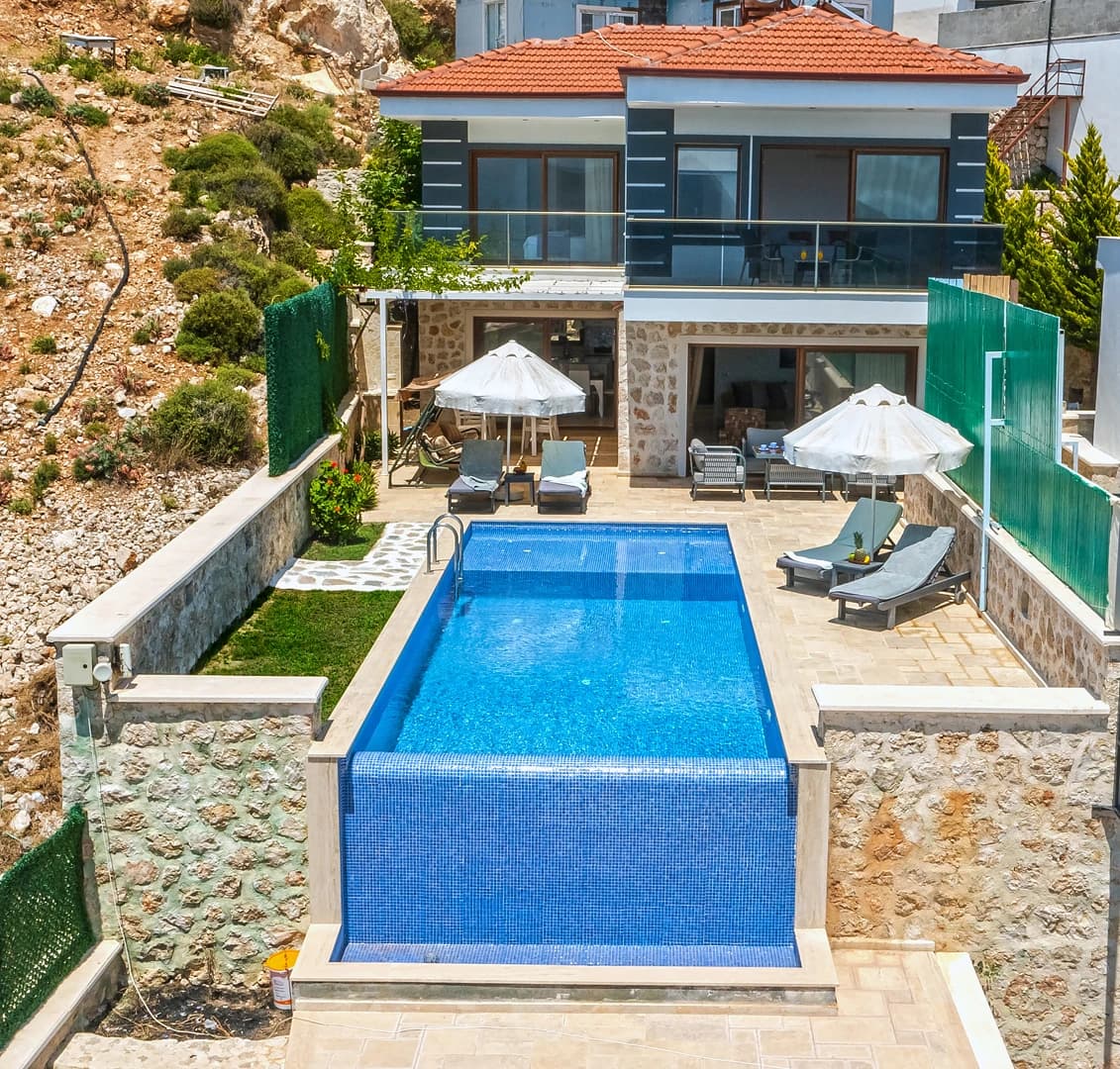 Modern villa with private pool, lounging areas, and manicured garden space.