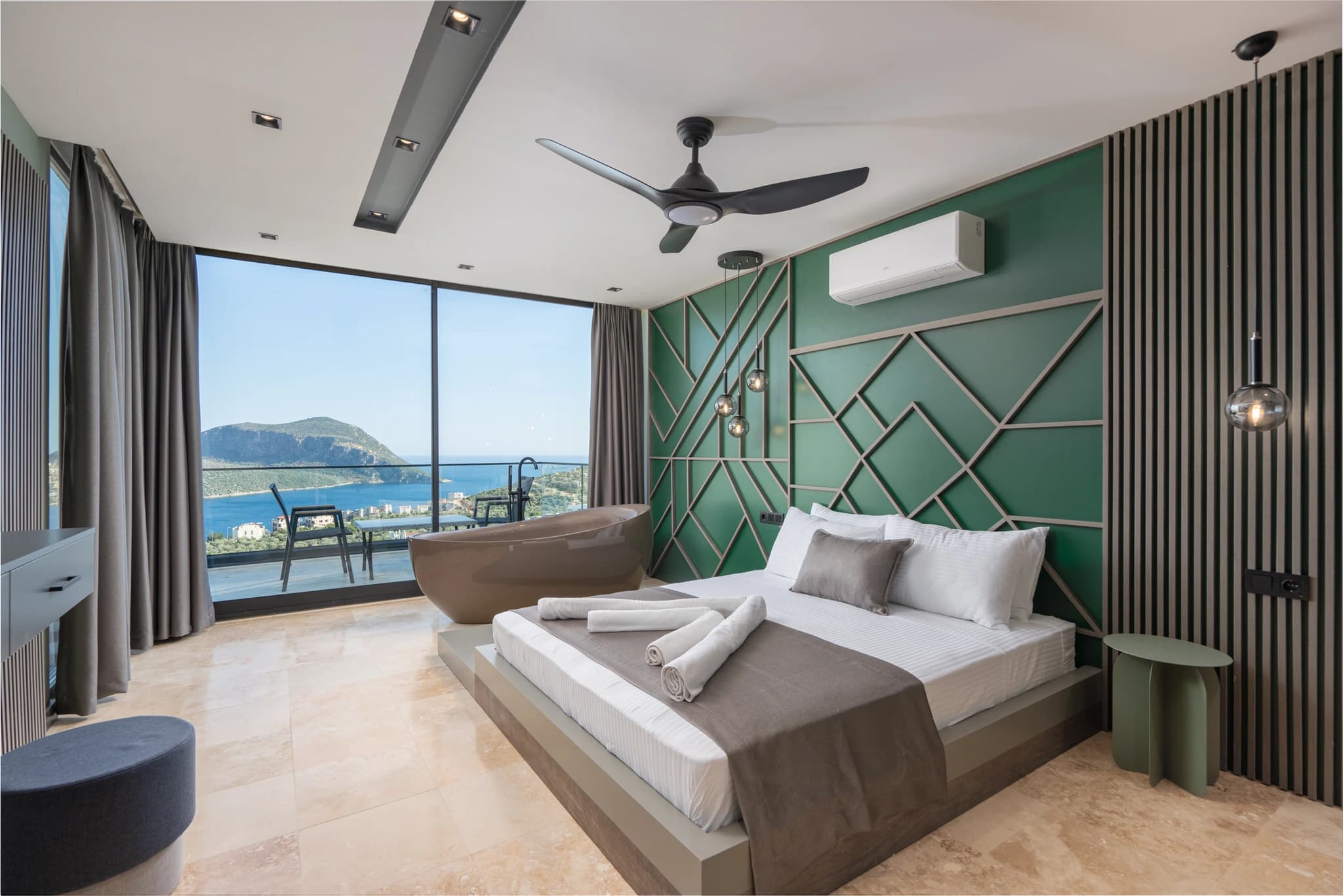 Luxurious bedroom with king bed, in-room jacuzzi bathtub, and panoramic sea views.