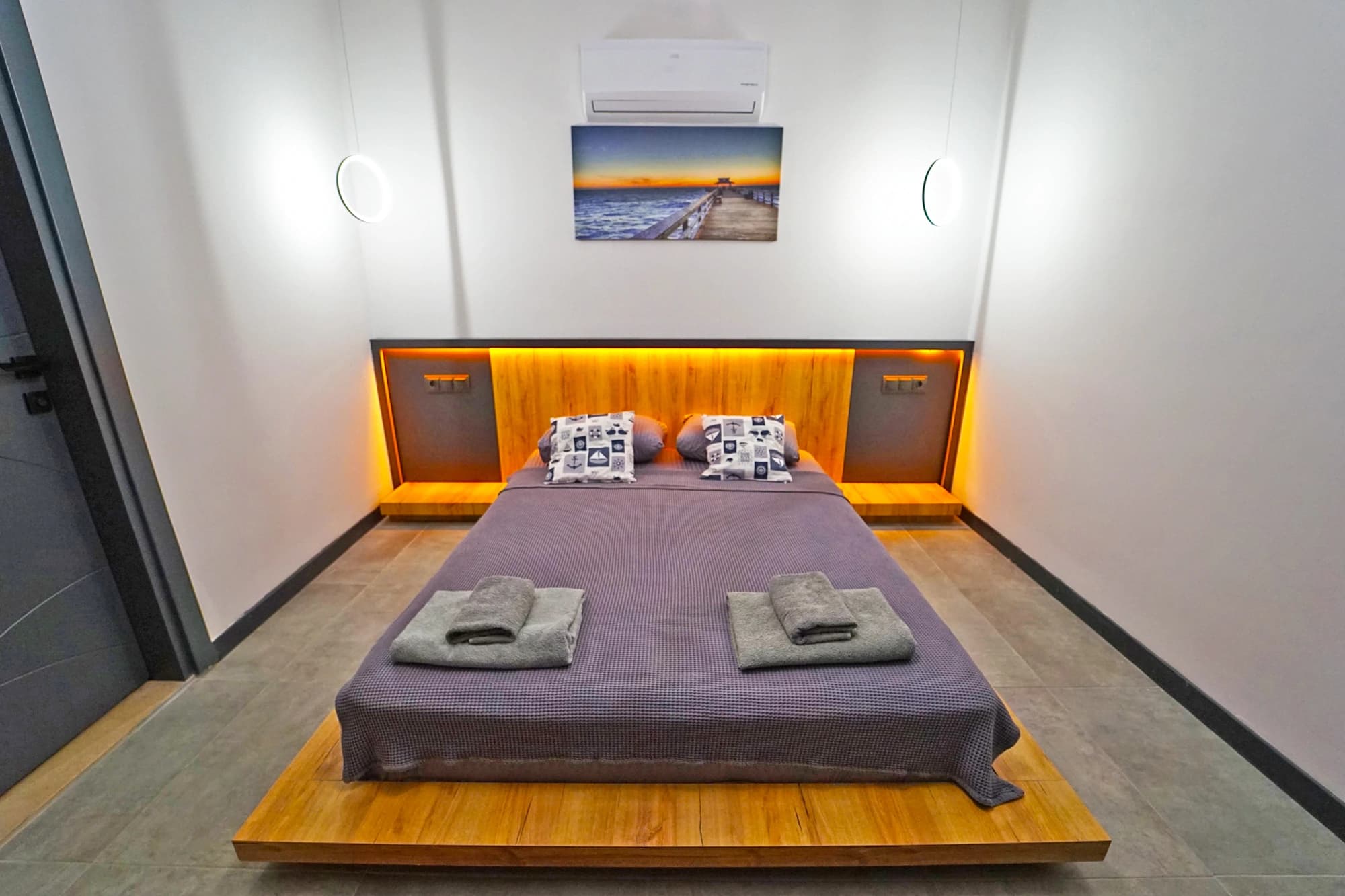 Contemporary bedroom featuring king bed with warm accent lighting and clean modern aesthetic.